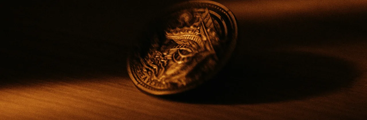 A single gold coin standing on dark wood in warm sidelight
