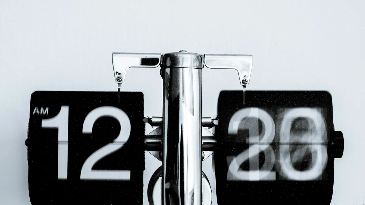 A flip clock against a plain wall
